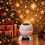 A white ball projector on a stand casts golden snowflakes on a wall beside a decorated Christmas tree.